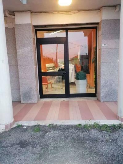 Locale commerciale al piano terra di un fabbricato da 4 piani fuori terra. Si sviluppa su pianta dalla forma irregolare. E’caratterizzato da 2 ampie vetrate di cui una funge da ingresso. All’interno è suddiviso secondo le esigenze dell’attività: è presente un piccolo bagno servizi per il personale dotato di lavabo e Wc, locale tecnico con serbatoio autoclave, un’area destinata a deposito e un’area in cui vengono riposti i prodotti per la consegna.